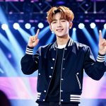 **

"A determined young man, resembling a K-Pop idol, stands on a brightly lit stage, fully clothed in a stylish performance outfit with modest details, appropriate attire. The background features a cheering crowd and vibrant stage lighting, reflecting the energy of a concert. Safe for work, perfect anatomy, correct proportions, natural pose, well-formed hands, proper finger count, professional, family-friendly, high quality, appropriate content."

**